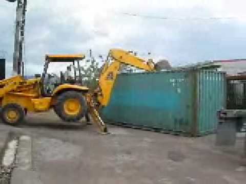 Shipping Containers in Costa Rica being unloaded with a Backhoe